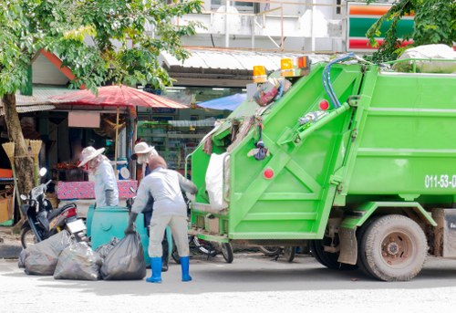 Workers loading bulky fixtures into a man-and-van at an industrial estate
